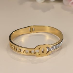 Gold chanel logo embellished hinged bangle
