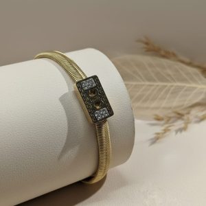 Gold bracelet with ornate clasp.